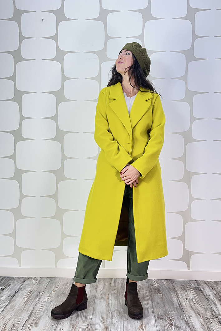 outfit con Cappotto Brilka lime, Maglia Overlap panna, Pantalone Luther verde, basco petiole verde e collana wire verde